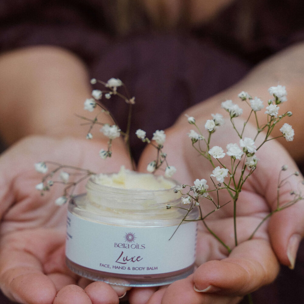 Bella Oils Luxe vegan balm used as part of a luxurious self-care ritual for soft, hydrated skin.